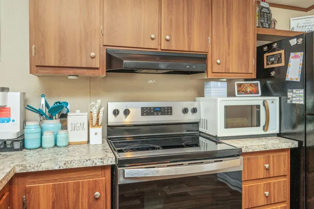 a stove top oven sitting inside of a kitchen