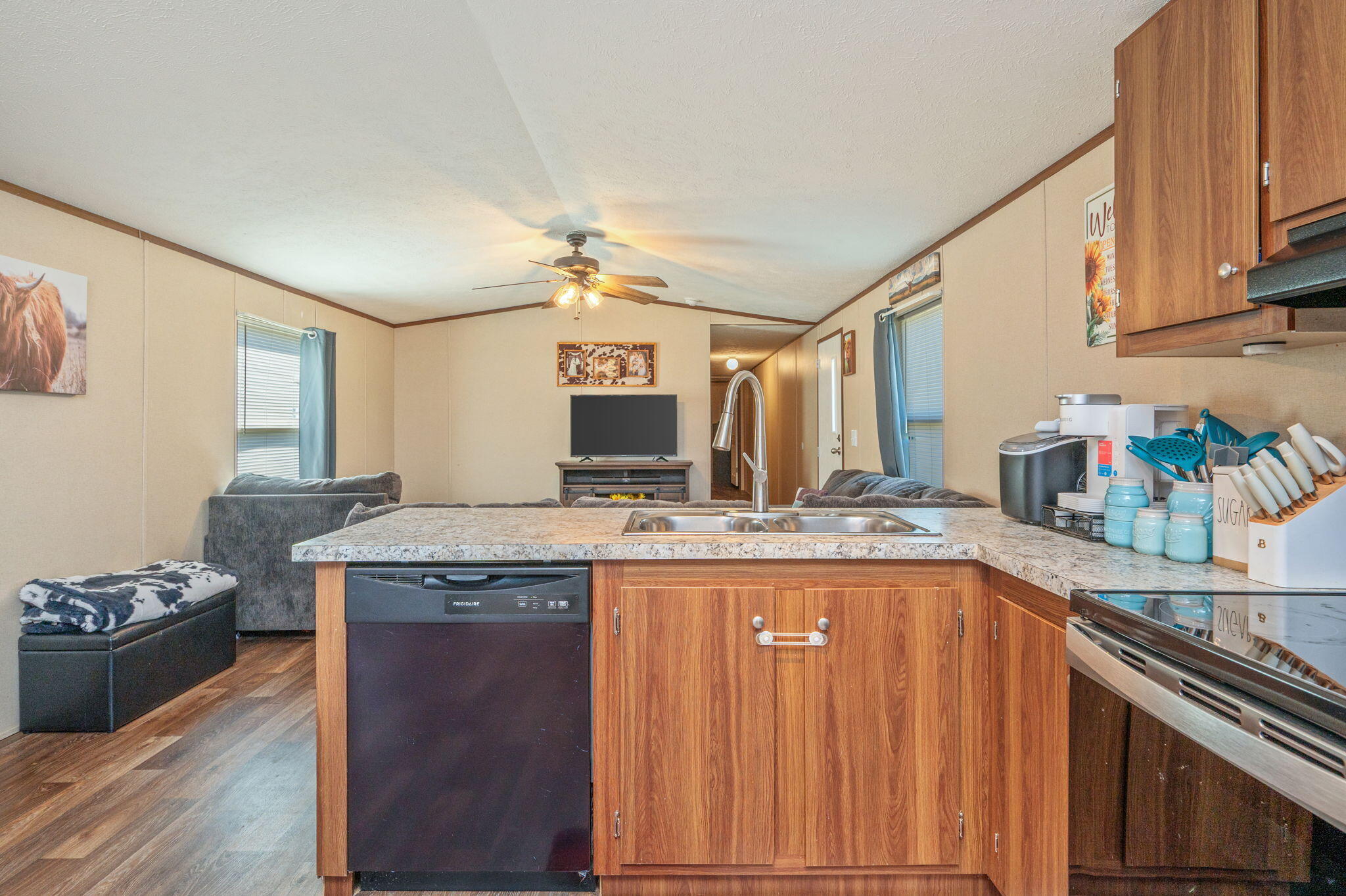 1424 East F Sanford Road Baker, FL 32531 - Photo 8 of 32 a kitchen with granite countertop a sink stove and cabinets