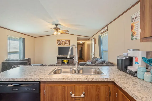 a kitchen with stainless steel appliances granite countertop a sink a stove and a microwave