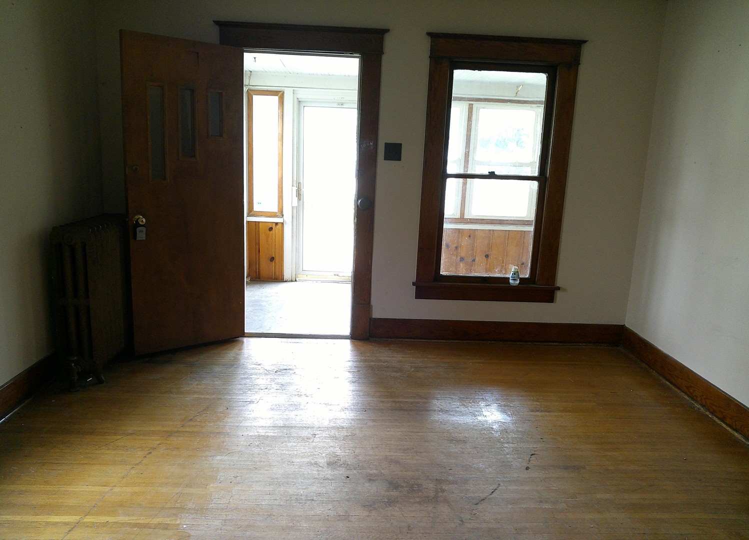 208 East State Street Fairmount, IL 61841 - Photo 3 of 21 an empty room with wooden floor and windows