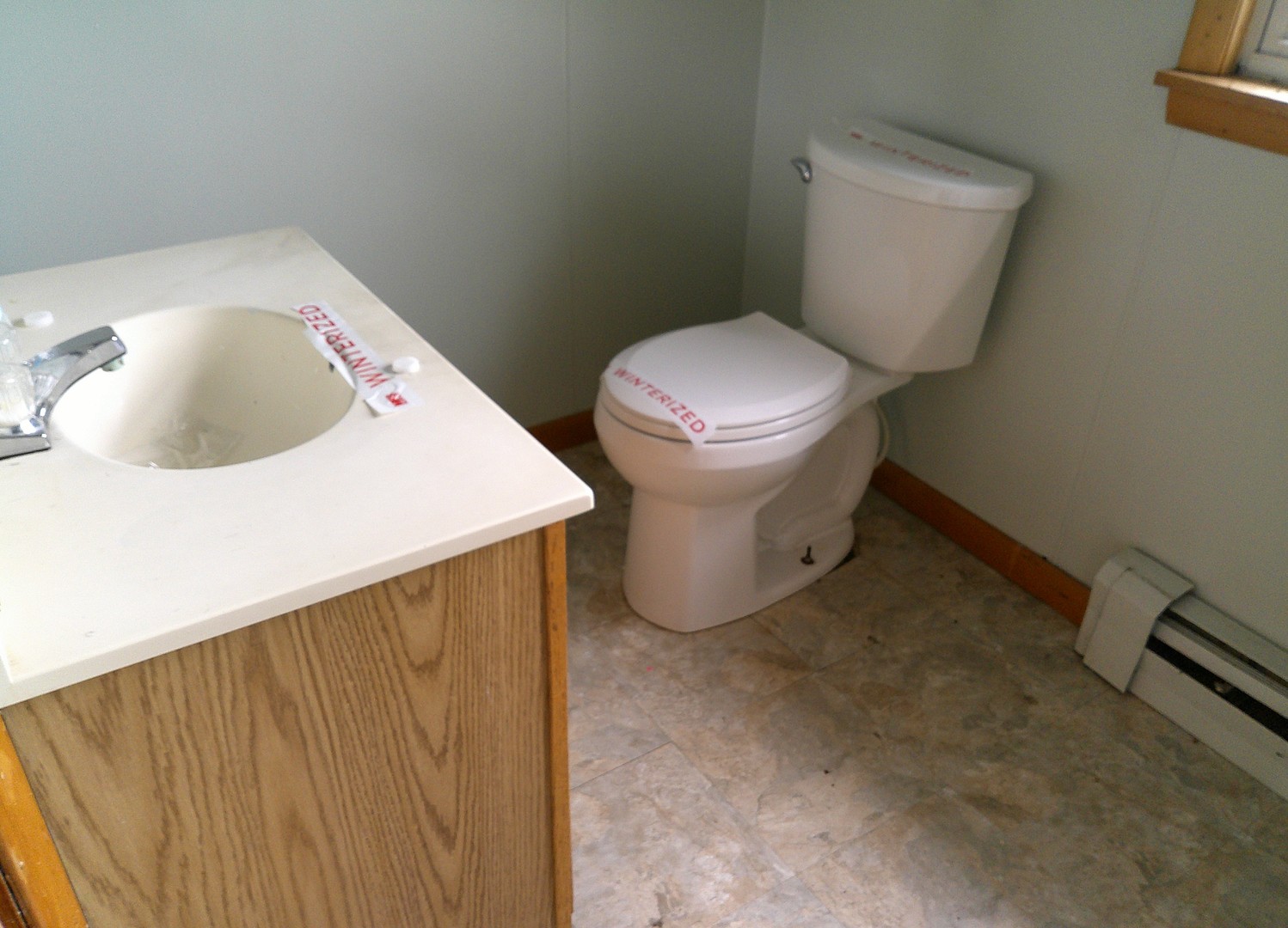 208 East State Street Fairmount, IL 61841 - Photo 9 of 21 a white toilet sitting next to a bathroom sink