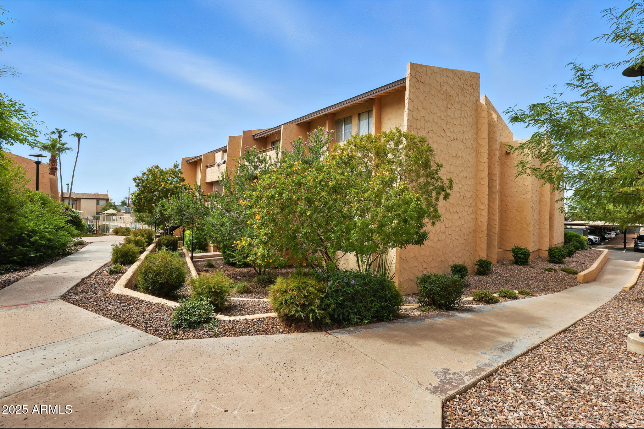 8055 East Thomas Road, Unit N201 Scottsdale, AZ 85251 - Photo 1 of 28 a front view of a house with garden