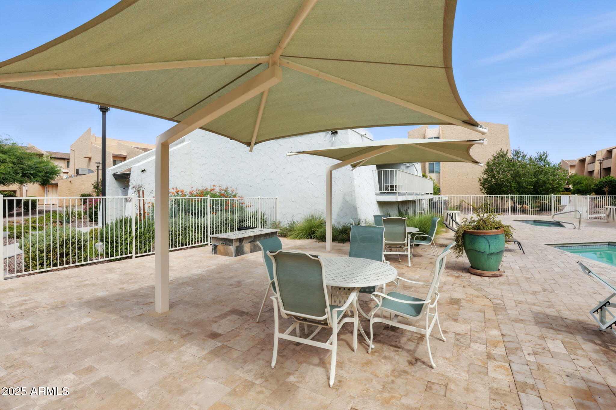 8055 East Thomas Road, Unit N201 Scottsdale, AZ 85251 - Photo 12 of 28 a view of patio with a table and chairs under an umbrella