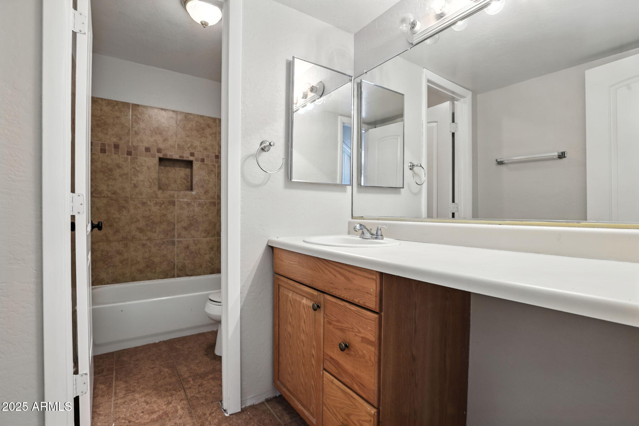 8055 East Thomas Road, Unit N201 Scottsdale, AZ 85251 - Photo 19 of 28 a bathroom with a shower sink and mirror