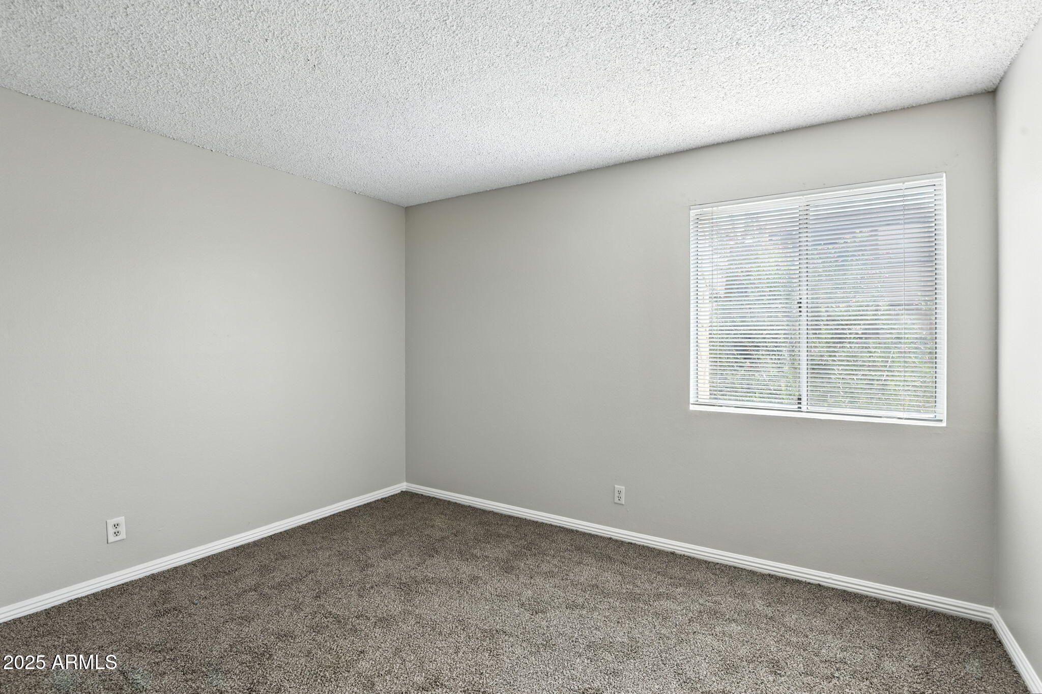 8055 East Thomas Road, Unit N201 Scottsdale, AZ 85251 - Photo 21 of 28 an empty room with a window