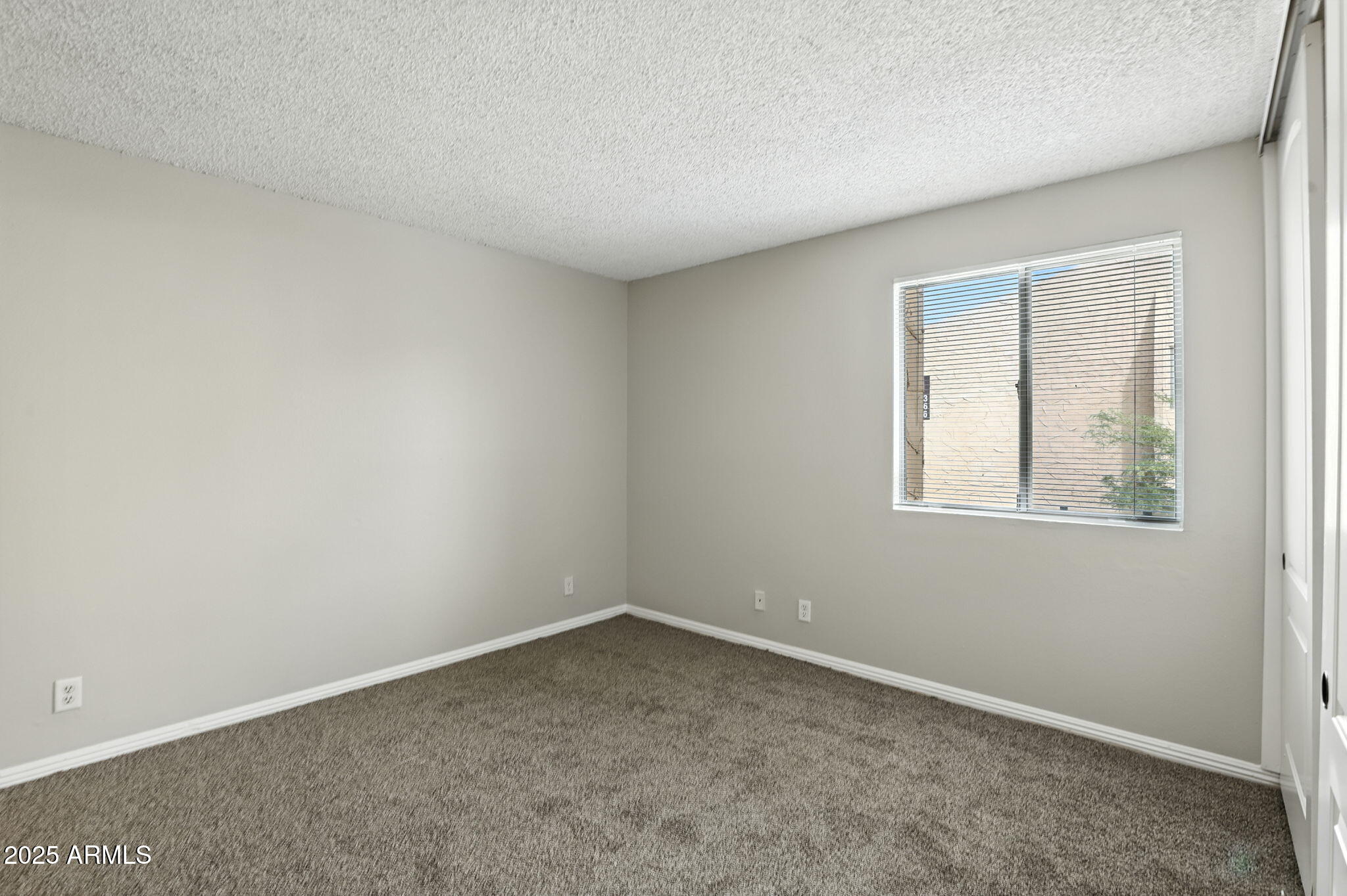 8055 East Thomas Road, Unit N201 Scottsdale, AZ 85251 - Photo 23 of 28 an empty room with a window
