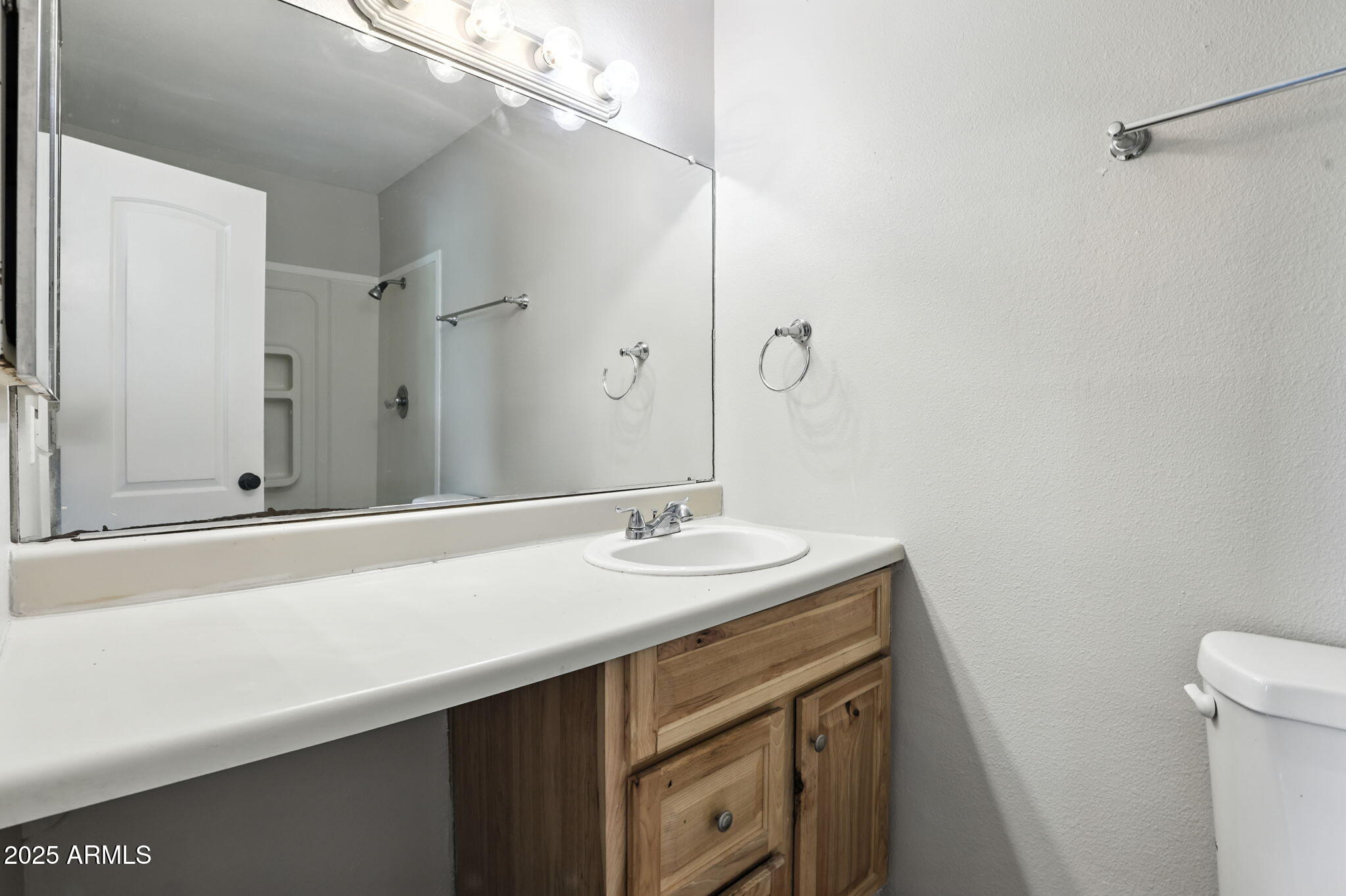 8055 East Thomas Road, Unit N201 Scottsdale, AZ 85251 - Photo 25 of 28 a bathroom with a sink and a mirror