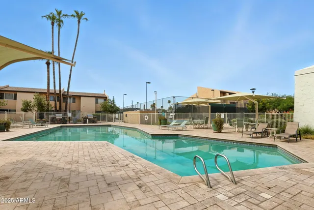 a view of a swimming pool and a yard