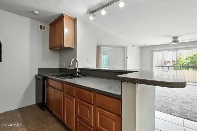 a kitchen with stainless steel appliances granite countertop a sink and a stove