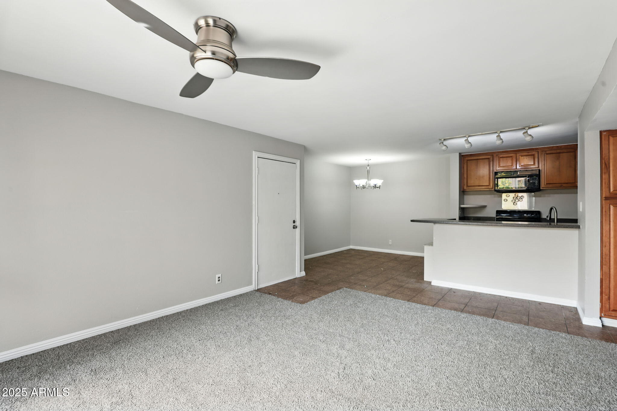 8055 East Thomas Road, Unit N201 Scottsdale, AZ 85251 - Photo 6 of 28 a view of a room with a hanging light and kitchen