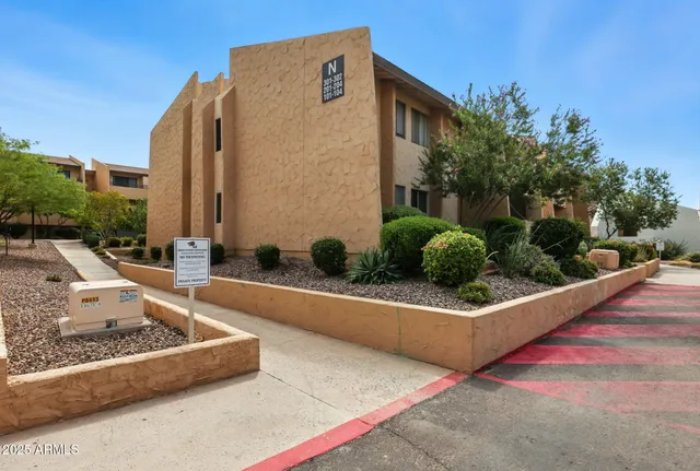 a view of a couches in the patio with a small yard