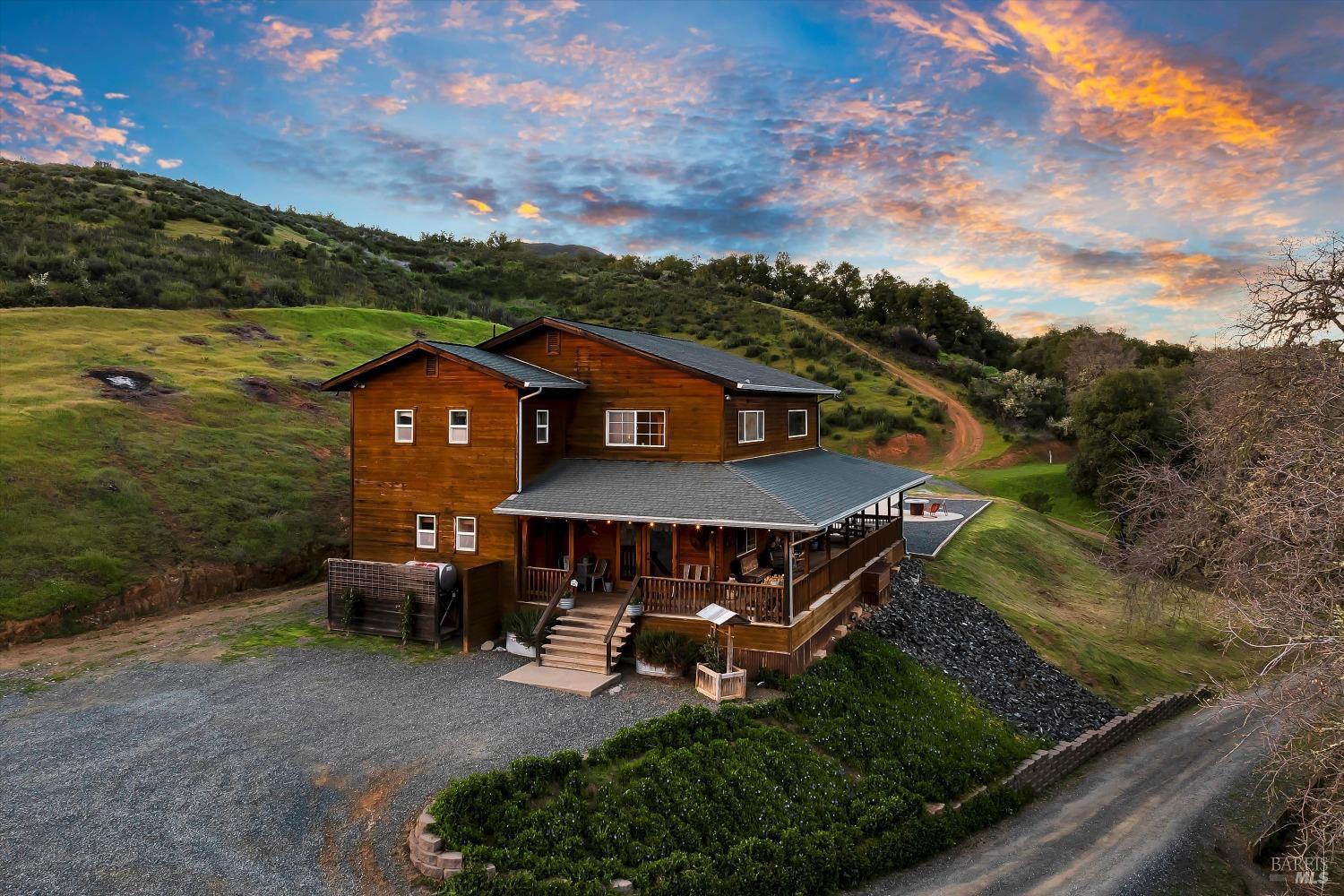 an aerial view of a house with garden space and street view