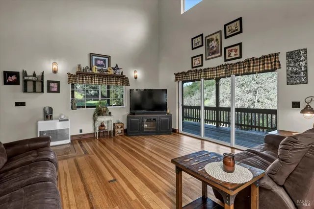 a view of entryway livingroom and hall with wooden floor
