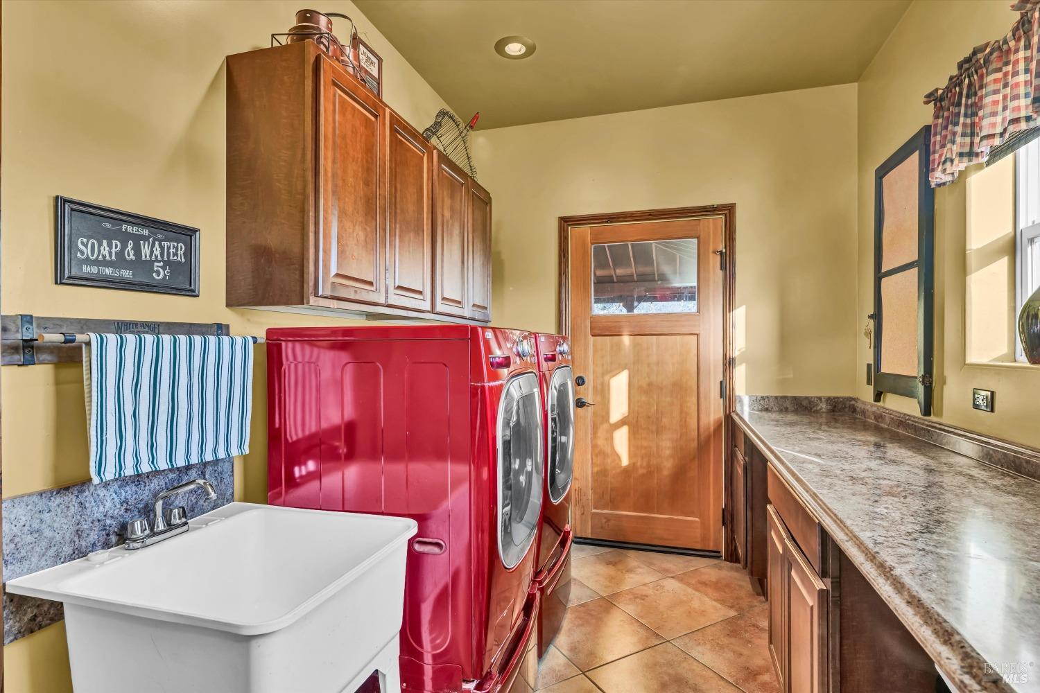 5963 Eickhoff Road Lakeport, CA 95453 - Photo 18 of 51 a bathroom with a granite countertop sink and a mirror