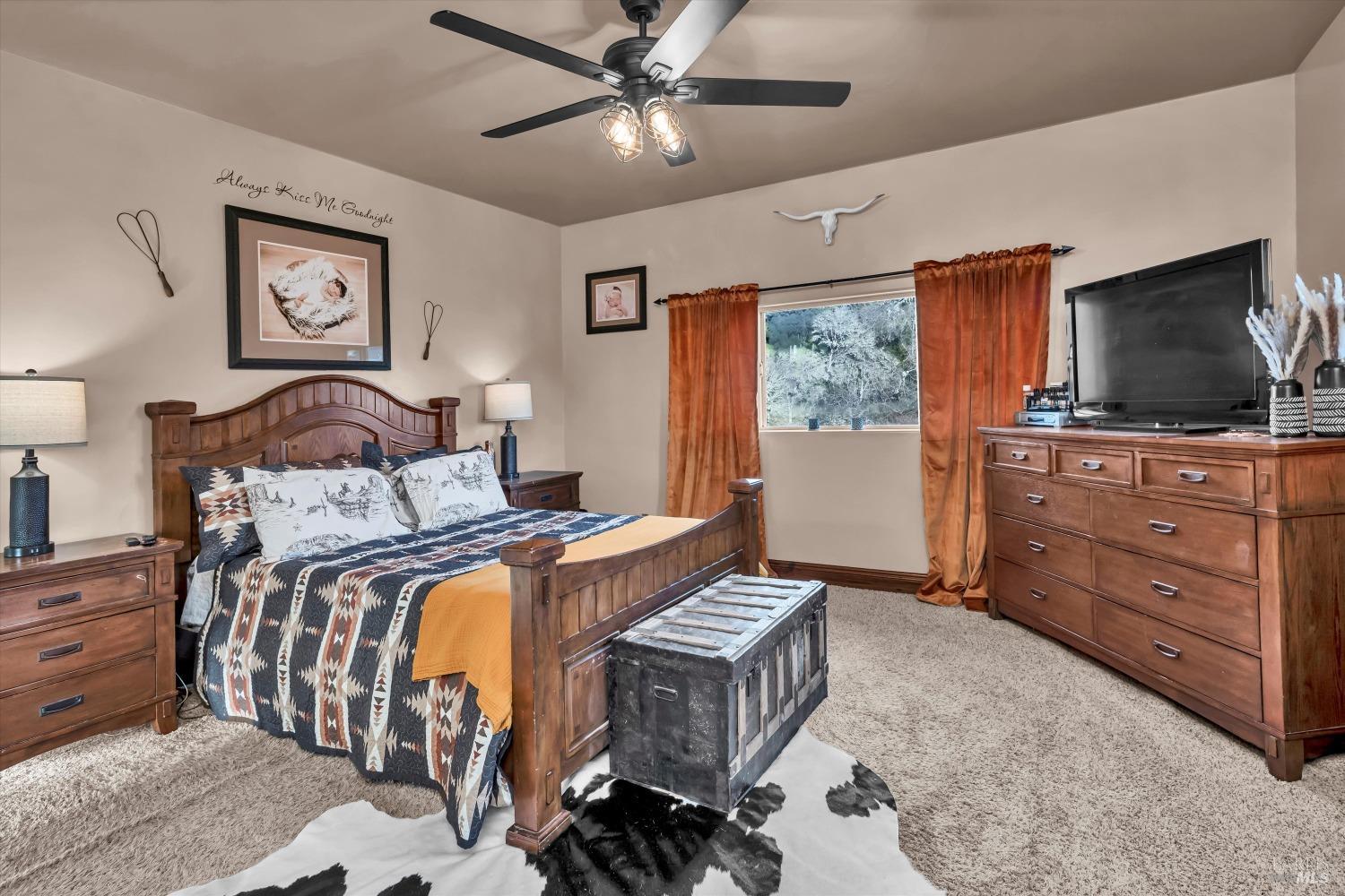 5963 Eickhoff Road Lakeport, CA 95453 - Photo 23 of 51 a bedroom with a bed and wooden floor