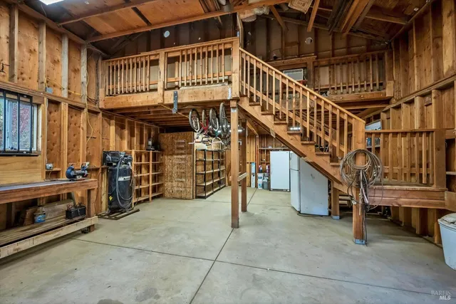 a view of a storage room with refrigerator and washer