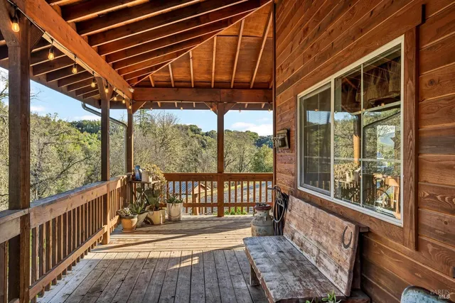 a view of a porch with wooden floor