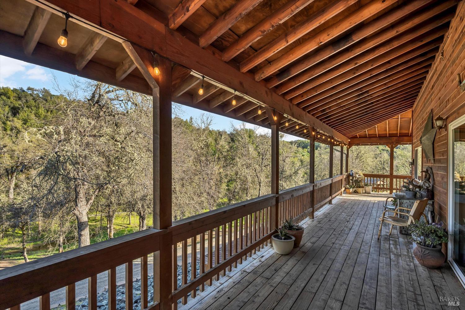 5963 Eickhoff Road Lakeport, CA 95453 - Photo 45 of 51 a view of a balcony with chairs and wooden floor
