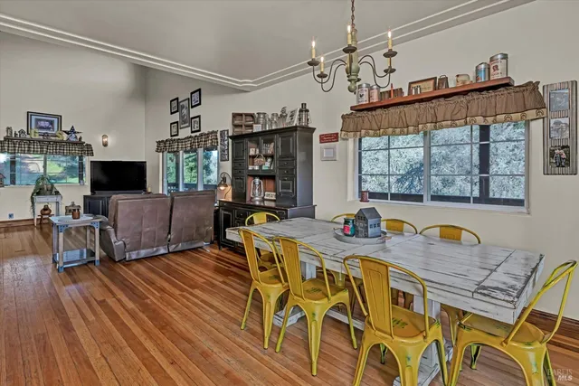 a view of a dining room with furniture wooden floor and chandelier