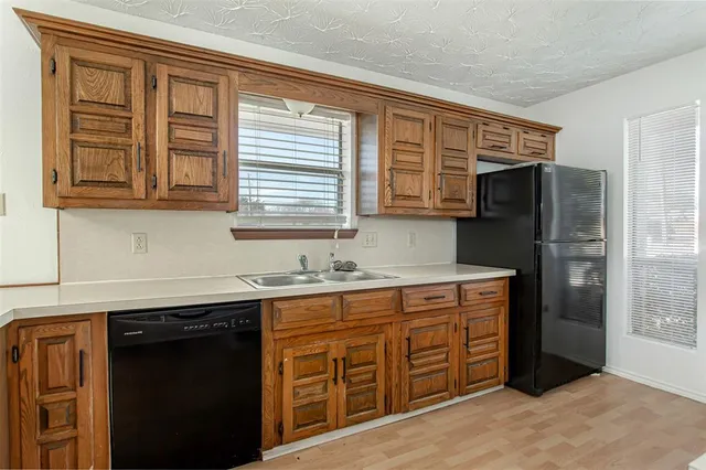 a kitchen with stainless steel appliances granite countertop a refrigerator and a sink