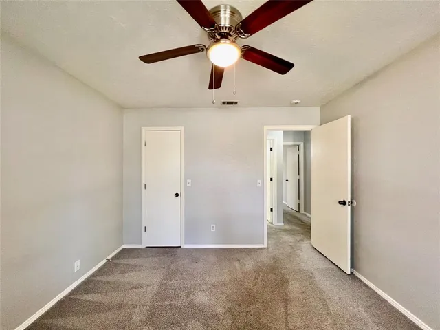 a bathroom with a granite countertop sink mirror toilet bathtub and vanity