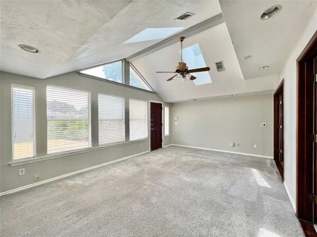 a view of a livingroom with a ceiling fan and chandelier fan