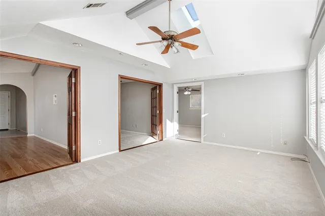 a view of a livingroom with a ceiling fan and window