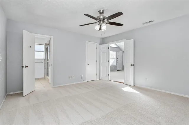 an empty room with fan and a ceiling fan