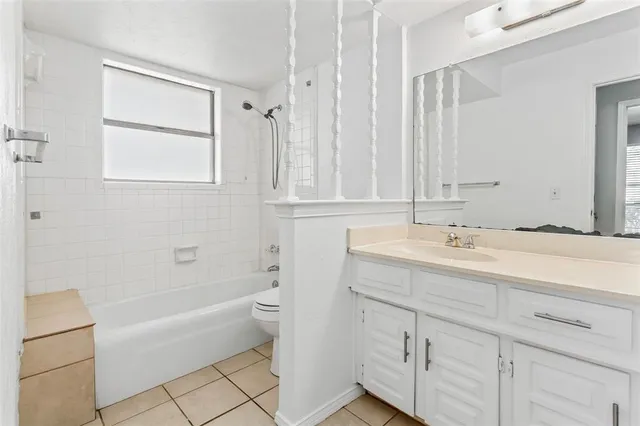 a bathroom with a tub sink and mirror