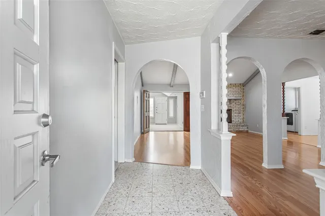 a view of a hallway view with wooden floor and living room