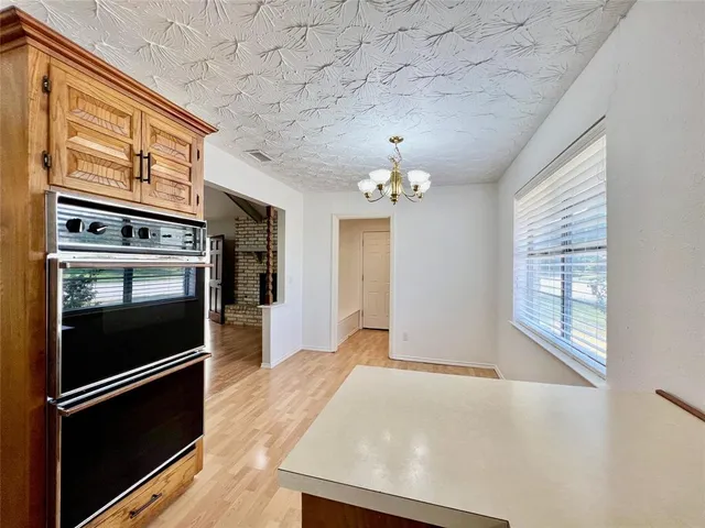 a view of a kitchen with a stove and cabinets