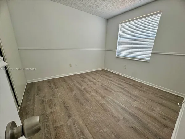 a bathroom with a sink a toilet a mirror and bathtub