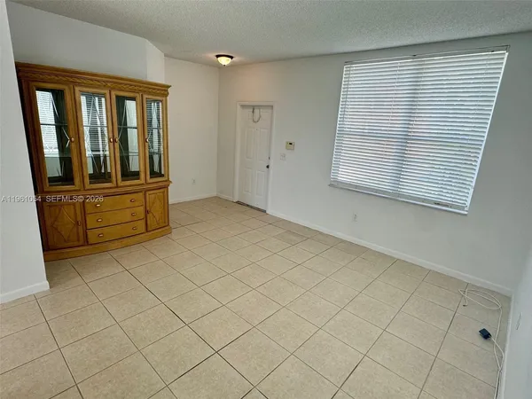 a kitchen with granite countertop a refrigerator and a sink