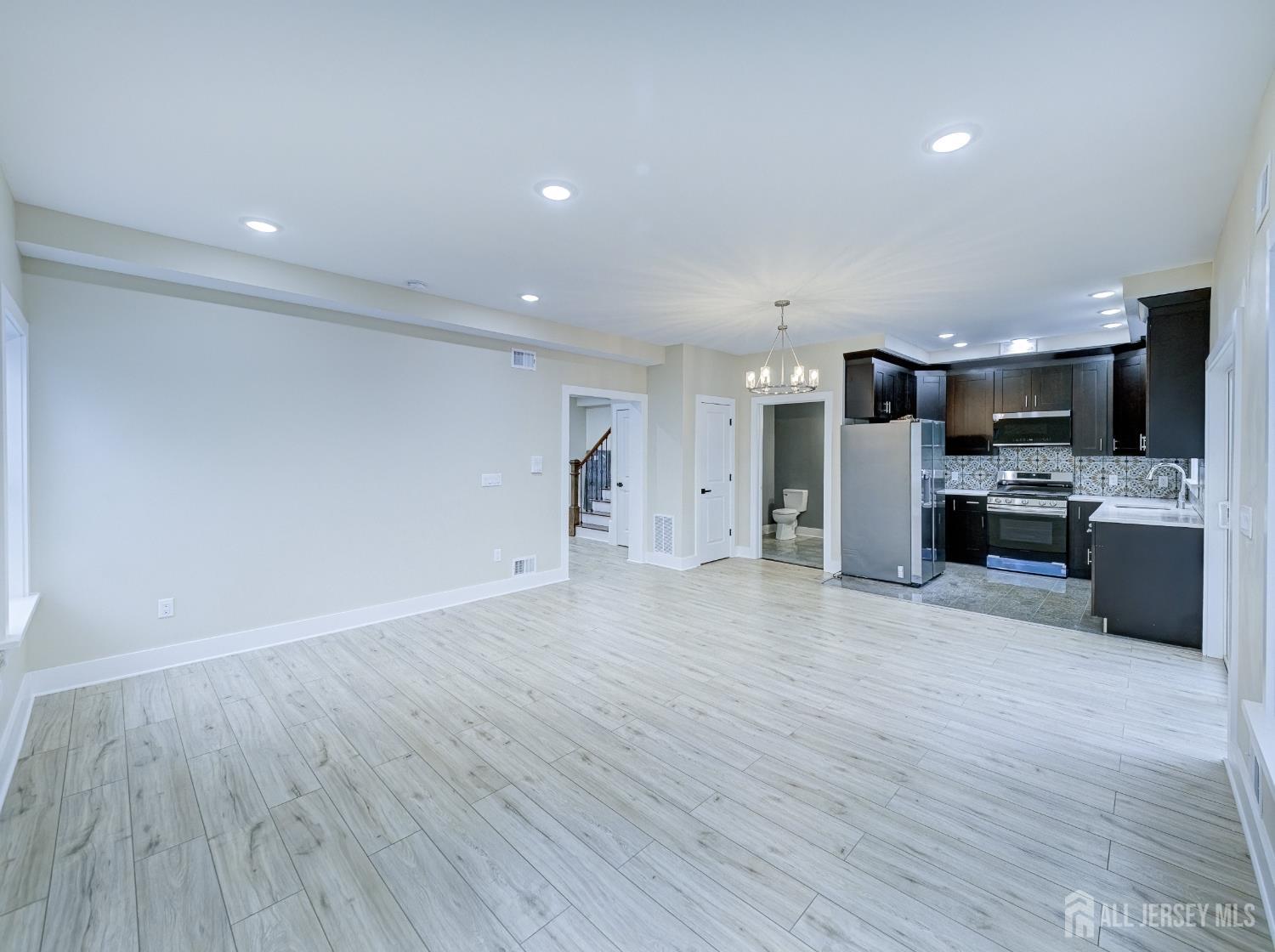 8 Travers Avenue, Unit 1 Edison, NJ 08817 - Photo 4 of 19 a view of kitchen with refrigerator microwave and wooden floor