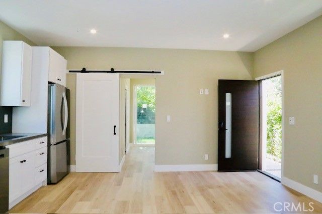 a view of a kitchen with a refrigerator and a sink