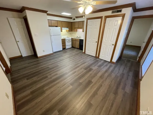 a view of a kitchen with wooden floor and electronic appliances
