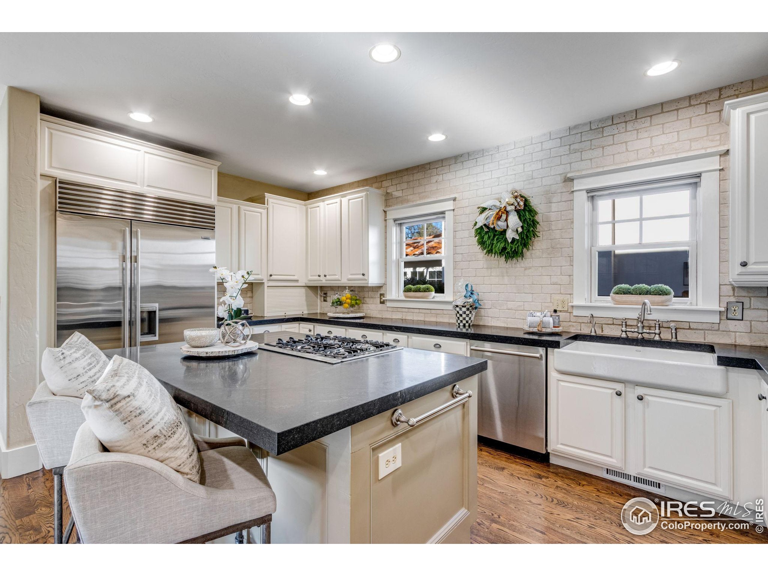 707 South Fillmore Street Denver, CO 80209 - Photo 29 of 49 a kitchen with granite countertop a sink stove and cabinets