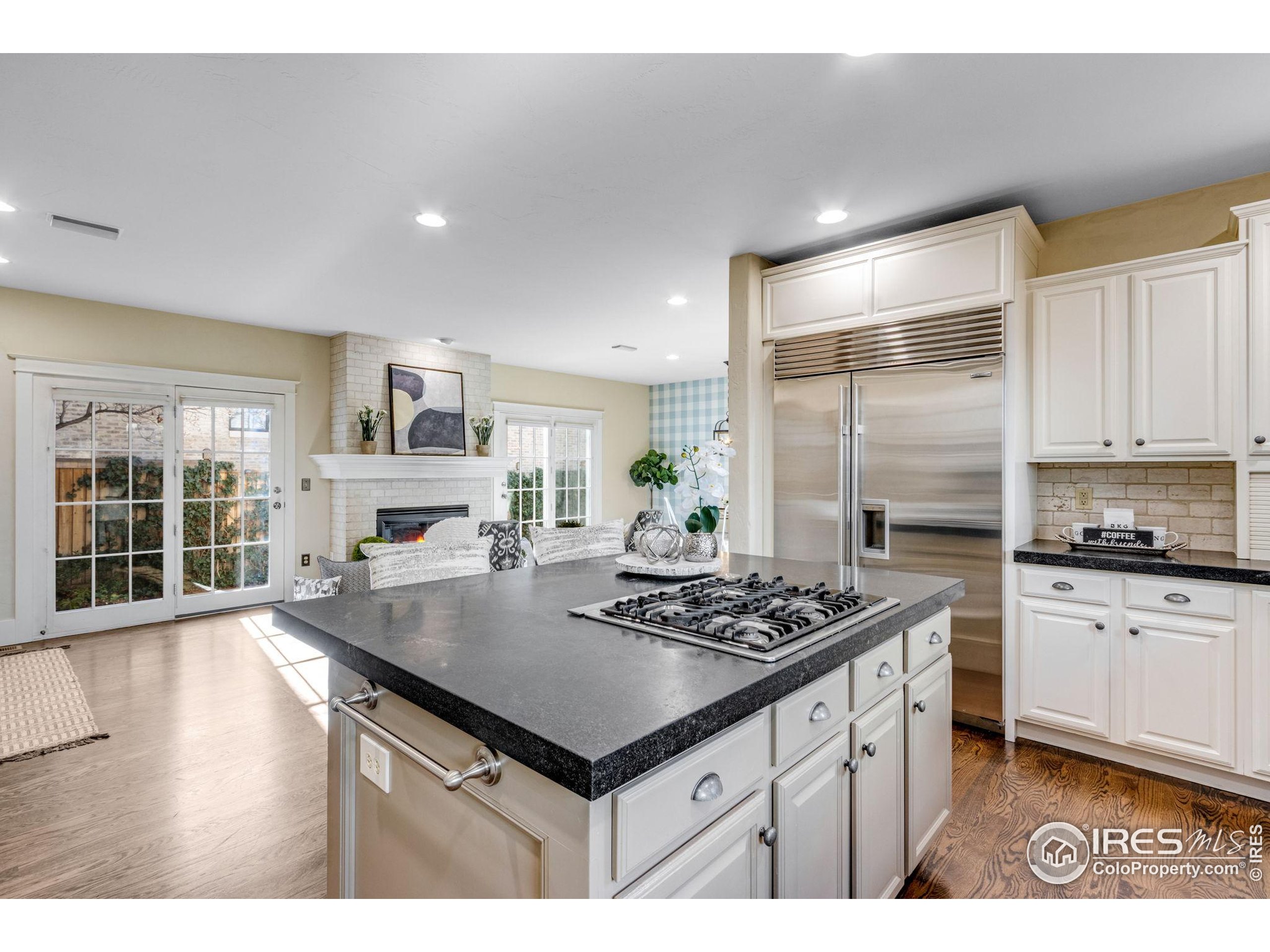 707 South Fillmore Street Denver, CO 80209 - Photo 30 of 49 a kitchen with stainless steel appliances granite countertop a sink stove and refrigerator