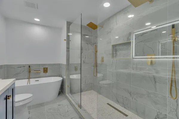 a bathroom with a bathtub shower sink and toilet