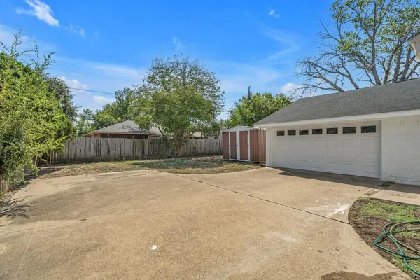 a backyard of a house with wooden fence