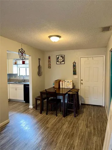 a view of a workspace with furniture and wooden floor