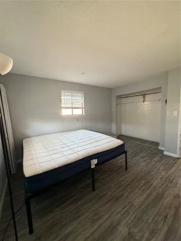 a room with wooden floor and window