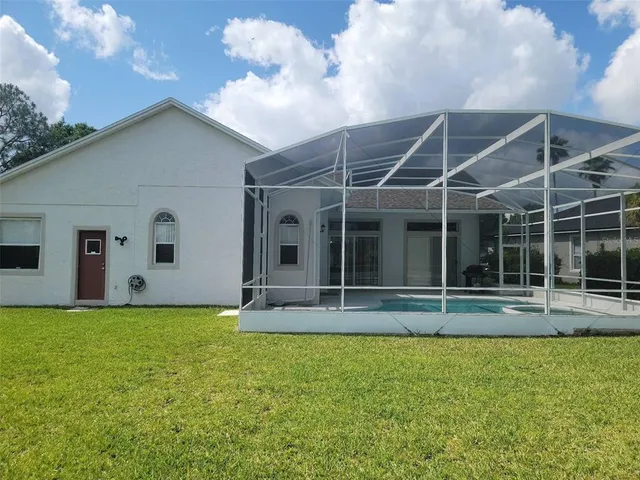 a view of a house with a backyard and porch