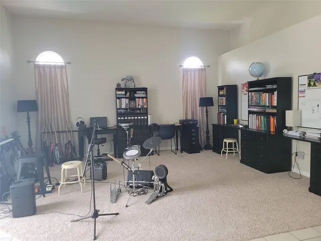 a work room with furniture and a book shelf