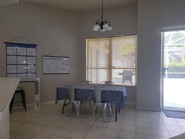 a view of a dining room with furniture and chandelier
