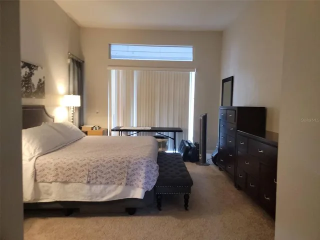 a bed room with a bed and a television