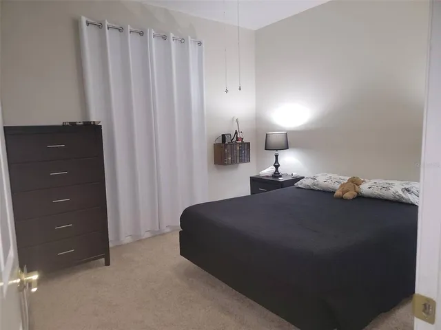 a bedroom with a bed and a lamp