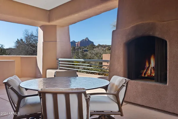 a view of a patio with dining table and chairs