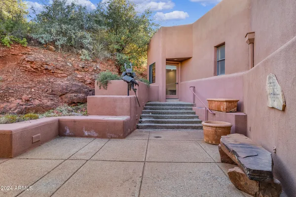 a dining hall with stainless steel appliances granite countertop a sink a stove and a refrigerator with wooden floor