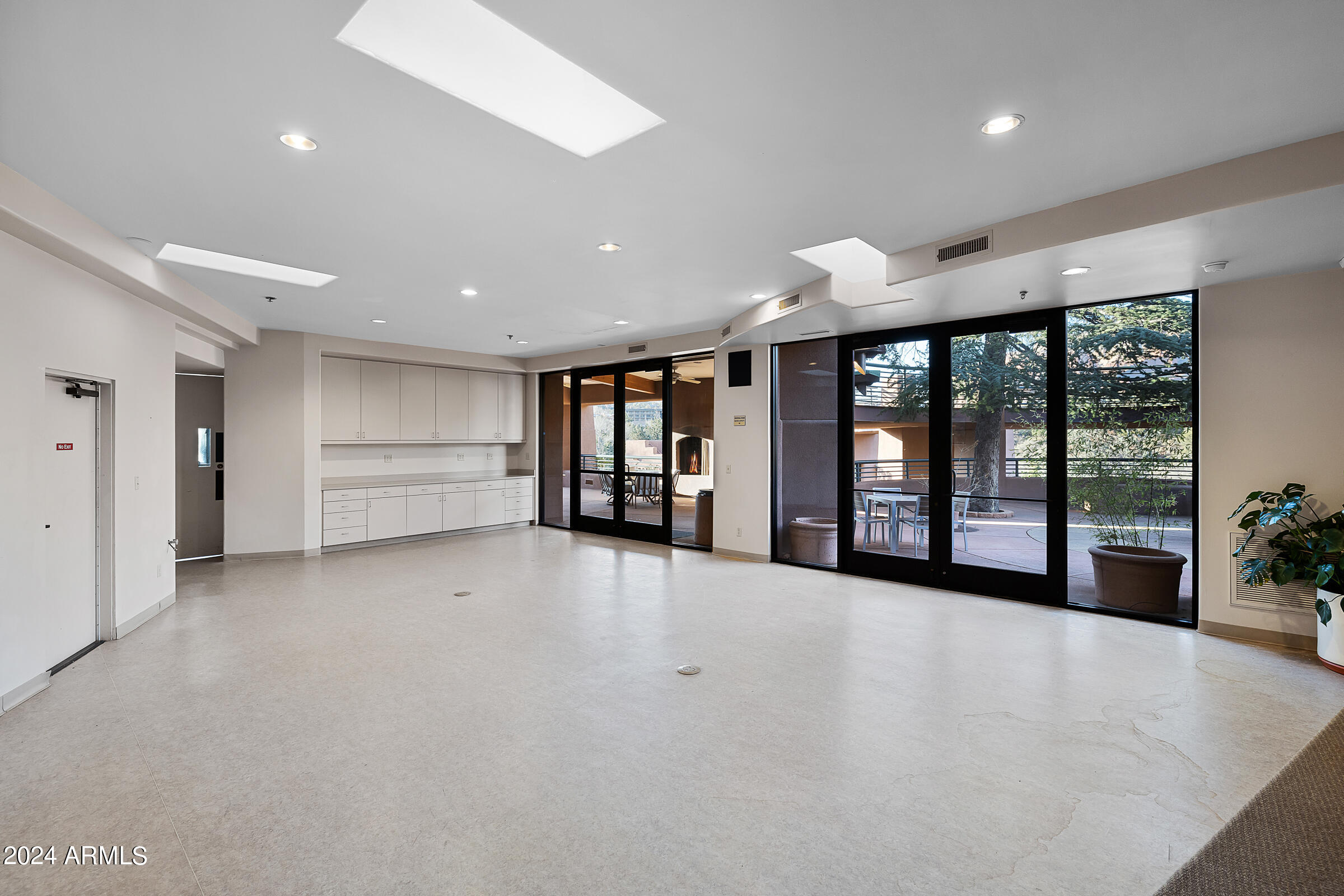 333 Schnebly Hill Road Sedona, AZ 86336 - Photo 39 of 69 an empty room with a large window and stainless steel appliances